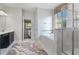 Bright bathroom with separate shower, garden tub, dark vanity and decorative window treatment at 1420 Mickelson Ct, Davenport, FL 33896
