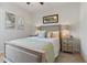 Comfortable bedroom featuring neutral walls, light-colored carpet, and framed art above the bed at 1420 Mickelson Ct, Davenport, FL 33896