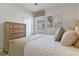 Bedroom with neutral decor, window with blinds, carpeted floors, and a light wood dresser at 1420 Mickelson Ct, Davenport, FL 33896