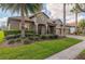 Charming single-story home with a manicured lawn, a tile roof and a three-car garage at 1420 Mickelson Ct, Davenport, FL 33896
