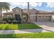 Charming single-story home with a tile roof, well-manicured lawn and a three-car garage at 1420 Mickelson Ct, Davenport, FL 33896