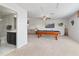 Open game room with a pool table and comfortable seating, seamlessly connected to the bathroom at 1420 Mickelson Ct, Davenport, FL 33896