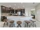 Spacious kitchen featuring an expansive island, stainless steel appliances, and dark cabinets at 1420 Mickelson Ct, Davenport, FL 33896