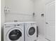 Functional laundry room with a modern washer and dryer, plus a convenient storage shelf at 1420 Mickelson Ct, Davenport, FL 33896