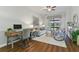 Comfortable living area with desk, sofa, chairs, and view to screened in patio at 1420 Mickelson Ct, Davenport, FL 33896