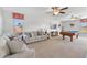 Spacious living room with neutral colored furniture, ceiling fans, and a wooden pool table at 1420 Mickelson Ct, Davenport, FL 33896