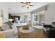 Open-concept living room featuring hardwood floors, access to lanai, and comfortable seating at 1420 Mickelson Ct, Davenport, FL 33896