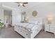 Bright main bedroom featuring a comfortable bed, side tables, and carpet flooring at 1420 Mickelson Ct, Davenport, FL 33896