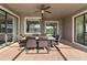 Covered patio featuring a dining set, offering a comfortable outdoor dining experience at 1420 Mickelson Ct, Davenport, FL 33896