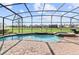 Screened-in pool with attached spa and beautiful golf course views at 1420 Mickelson Ct, Davenport, FL 33896