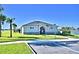 Exterior view of the community clubhouse, set against a serene lakeside backdrop and clear sky at 1493 Leamington Ln, Winter Haven, FL 33884