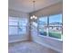 Bright dining area with large windows and contemporary chandelier fixture at 1493 Leamington Ln, Winter Haven, FL 33884