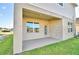 Covered patio with a view of the spacious backyard and neighboring properties at 1493 Leamington Ln, Winter Haven, FL 33884