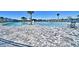 Expansive pool area featuring large gray pavers, lounge chairs and stunning water views at 1501 Leamington Ln, Winter Haven, FL 33884