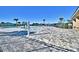 Resort-style swimming pool area featuring gray pavers, palm trees, and ample space for lounging at 1501 Leamington Ln, Winter Haven, FL 33884