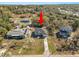 Aerial view of a charming home, with a long driveway and well-maintained lawn at 151 3Rd Ave, Babson Park, FL 33827