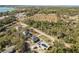 Expansive aerial view of home showcasing the property's location amidst a blend of natural landscapes and distant buildings at 151 3Rd Ave, Babson Park, FL 33827