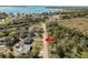 Aerial view of a home by a lake, highlighting its location near a body of water and surrounding landscape at 151 3Rd Ave, Babson Park, FL 33827