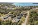 Wide aerial shot of home near a body of water and surrounding landscape, including buildings, trees, and grass at 151 3Rd Ave, Babson Park, FL 33827