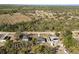 Aerial view showcasing a home surrounded by lush greenery and a tranquil setting at 151 3Rd Ave, Babson Park, FL 33827