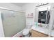 Clean bathroom featuring a shower-tub combo with glass doors, vanity with storage, and modern fixtures at 151 3Rd Ave, Babson Park, FL 33827