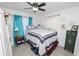 Cozy bedroom featuring stylish curtains, a ceiling fan, and comfortable furnishings, perfect for relaxation at 151 3Rd Ave, Babson Park, FL 33827