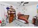 Nicely decorated bedroom featuring a cozy bed, wooden desk with storage, and neutral decor at 151 3Rd Ave, Babson Park, FL 33827