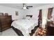 Spacious bedroom featuring a ceiling fan, wood-look floors, and a comfortable bed with ample natural light at 151 3Rd Ave, Babson Park, FL 33827