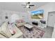 Comfortable living room with large TV, tile flooring, and light colored walls at 151 3Rd Ave, Babson Park, FL 33827