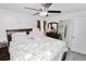 Comfortable main bedroom featuring a ceiling fan, dresser, and an ensuite bathroom at 151 3Rd Ave, Babson Park, FL 33827