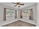 Bedroom with wood-look flooring and natural light from two windows at 1518 Avenue C Ne, Winter Haven, FL 33881