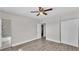 Spacious bedroom featuring closet, ceiling fan and wood-look flooring at 1518 Avenue C Ne, Winter Haven, FL 33881