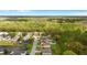 An aerial view of a neighborhood with backyard pools surrounded by trees and well-maintained lawns at 1526 Country Chase St, Lakeland, FL 33810