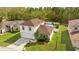 Aerial view of a two-story home with an attached two car garage, landscaped yard, and above ground pool at 1526 Country Chase St, Lakeland, FL 33810