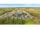 Beautiful aerial view of a neighborhood with a pond surrounded by lush trees and well-maintained homes at 1526 Country Chase St, Lakeland, FL 33810