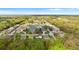 Beautiful aerial view of a neighborhood with a pond surrounded by lush trees and well-maintained homes at 1526 Country Chase St, Lakeland, FL 33810