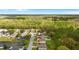 An aerial view of a neighborhood with backyard pools surrounded by trees and well-maintained lawns at 1526 Country Chase St, Lakeland, FL 33810