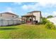 A backyard featuring a gazebo with hammock, above ground pool, and lush green lawn at 1526 Country Chase St, Lakeland, FL 33810