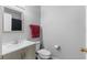 Bathroom featuring a single sink vanity, toilet and shower with red towel at 1526 Country Chase St, Lakeland, FL 33810