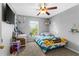 A cozy bedroom featuring a desk, a bed and a ceiling fan at 1526 Country Chase St, Lakeland, FL 33810