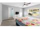Bedroom with a TV, carpet, and a window overlooking the outdoors at 1526 Country Chase St, Lakeland, FL 33810