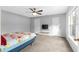 Spacious bedroom with a ceiling fan, carpeted floor, and natural light at 1526 Country Chase St, Lakeland, FL 33810