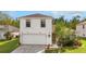 Charming two-story home featuring a two-car garage and a neatly landscaped front yard at 1526 Country Chase St, Lakeland, FL 33810