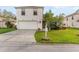 Inviting two-story home showcasing a well-maintained lawn and charming front yard landscaping at 1526 Country Chase St, Lakeland, FL 33810