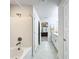 Bathroom featuring a shower-tub combo, neutral color palette, and access to the main bedroom at 153 Heritage Park Ln, Mulberry, FL 33860