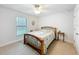 Cozy bedroom features carpet flooring, window, and a comfortable bed creating a restful environment at 153 Heritage Park Ln, Mulberry, FL 33860