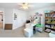 Bedroom featuring carpeted floors, ceiling fan, and is well-lit from the large window at 153 Heritage Park Ln, Mulberry, FL 33860