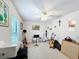 Carpeted bedroom features a ceiling fan and several decorations and offers a comfortable atmosphere at 153 Heritage Park Ln, Mulberry, FL 33860