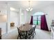 Formal dining room featuring a wooden table, seating for six, and a large arched window at 153 Heritage Park Ln, Mulberry, FL 33860