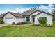Close-up of a well-maintained single Gathering home, featuring an attached garage and manicured lawn at 153 Heritage Park Ln, Mulberry, FL 33860